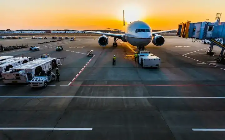 Passenger and cargo aircraft on an airport apron at sunset